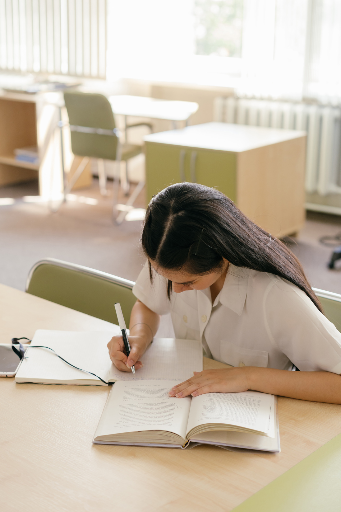 Woman in White Shirt Writing on White Paper